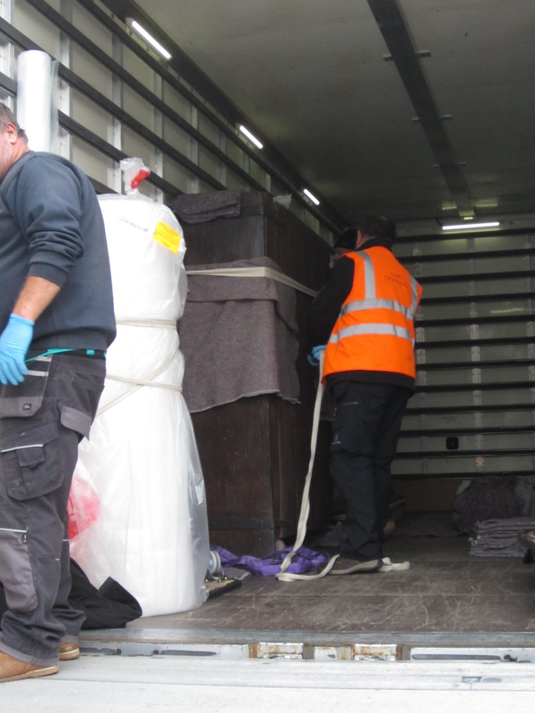 Securing the cubborde in the back of the moving van