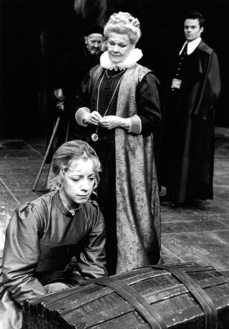 Judy Dench as the Countess stands looking at Helen kneeling at her trunk in the foreground. There are two men in the backround.