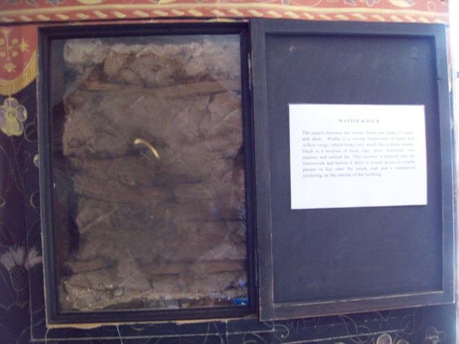 A transparent box showing an example of wattle and daub from Shakespeare Birthplace. It shows strips of wood being woven into the timber frame which was then sealed or daubed over by a mixture of wet soil, animal dung and straw.