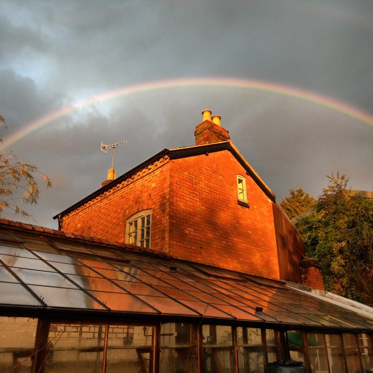 New Place, rainbow over glasshouse