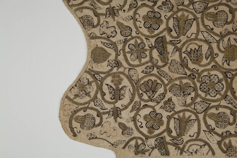 detail of embroidery on coif cap