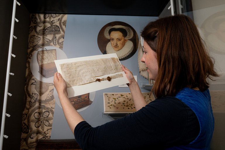 Amy Hurst, Collections Manager with the John and Mary document.